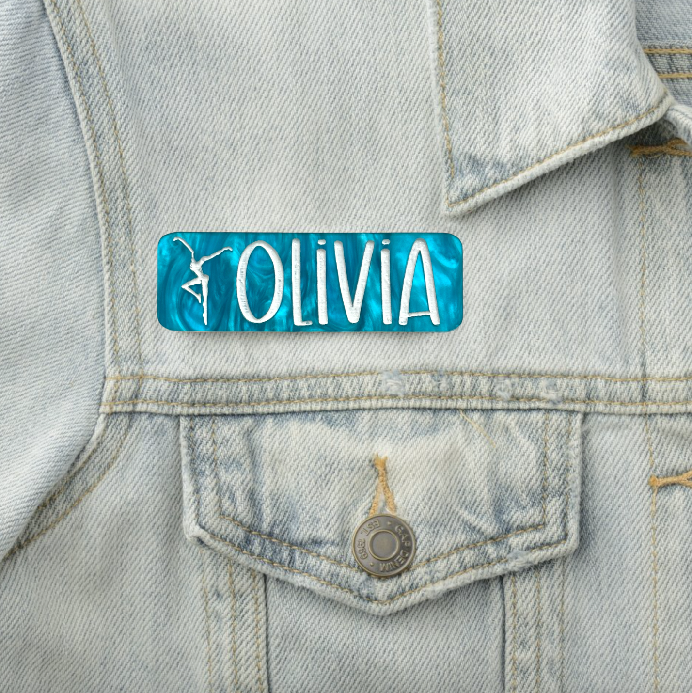 a close up of a jean jacket with a name tag on it