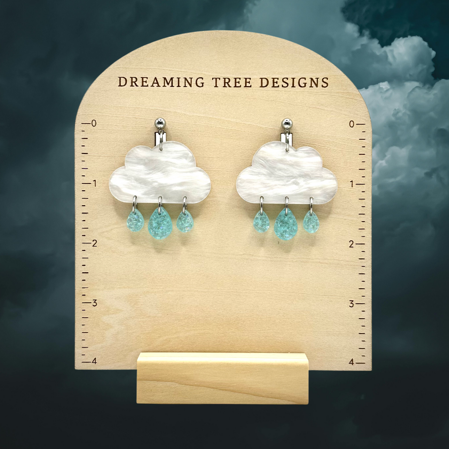 a pair of earrings is shown on a ruler