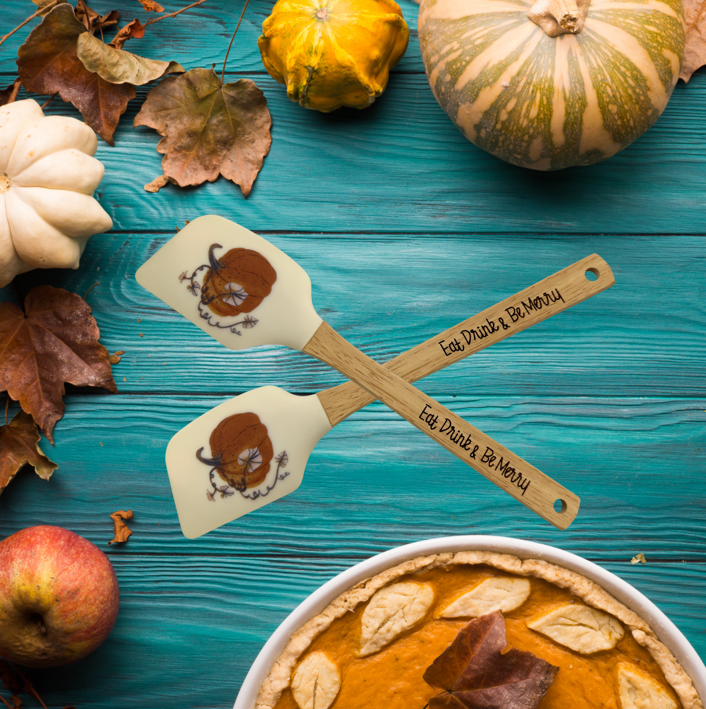 a pumpkin pie with two spoons on top of it