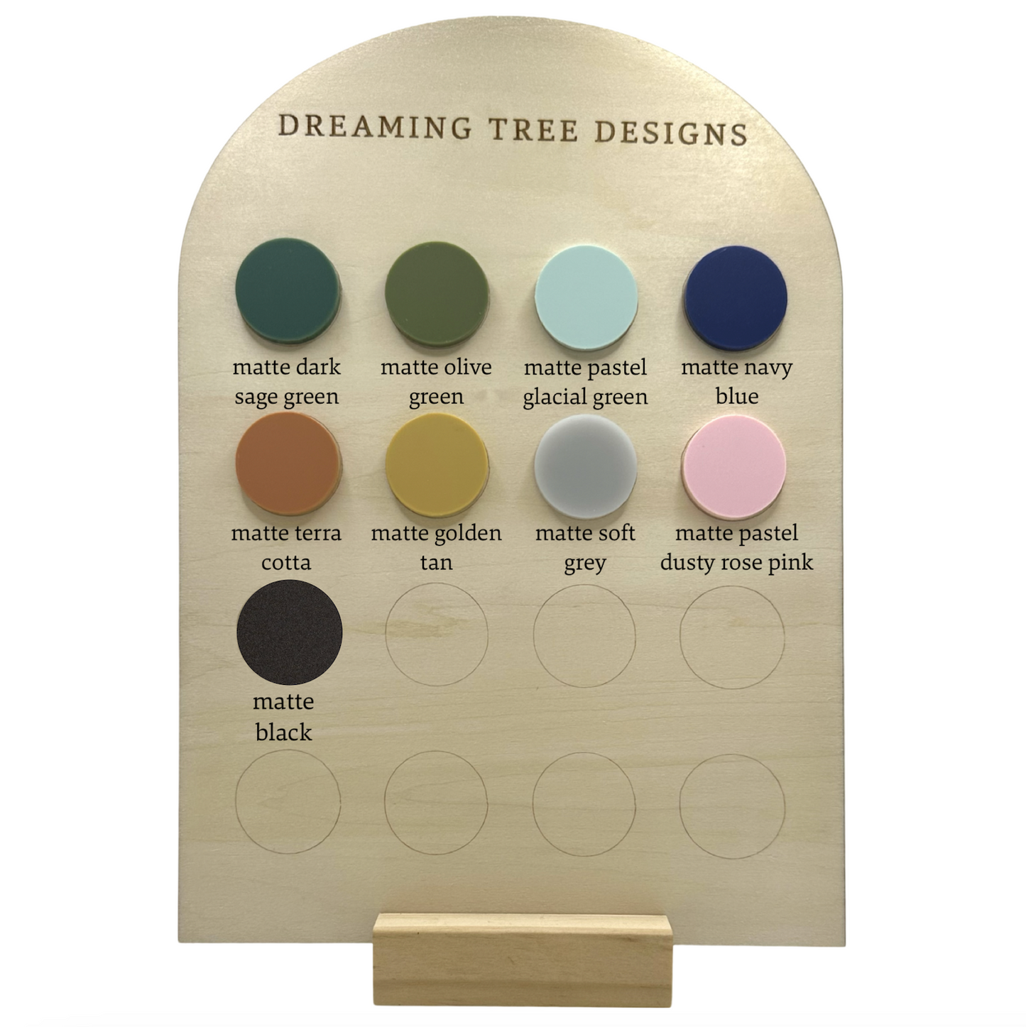 a wooden plaque with different colors of paint on it