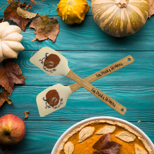 a pumpkin pie with two spoons on top of it