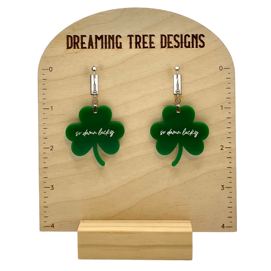 a pair of earrings with a four leaf clover